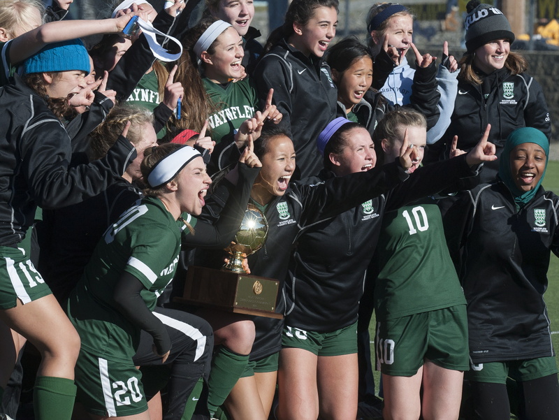 Waynflete girls soccer players celebrate their victory in the Class C state championship game in Hampden, Maine Saturday, Nov. 9, 2013.