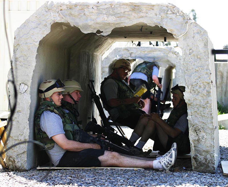 Staff photo by Gregory Rec -- Sunday, April 11, 2004 -- Soldiers from the 133rd Engineer Battalion wait in concrete c bunkers for an all clear during a mortar attack at Camp Marez on Sunday. Sunday was an unusually heavy day of shelling with a dozen or so mortars fired into the camp.