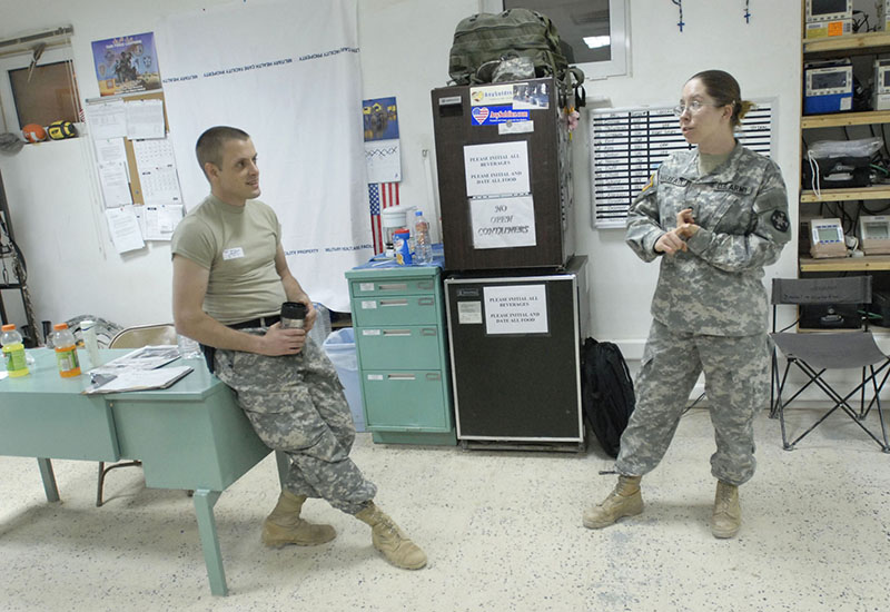 Shawn Patrick Ouellette/Staff Photographer Sgt. Tim Verreault and Spc. Jessica Verreault of Auburn, talk during a slow moment in the Emergency Medical Treatment Unit Wednesday night at the Army Reserve's 399th Combat Support Hospital.