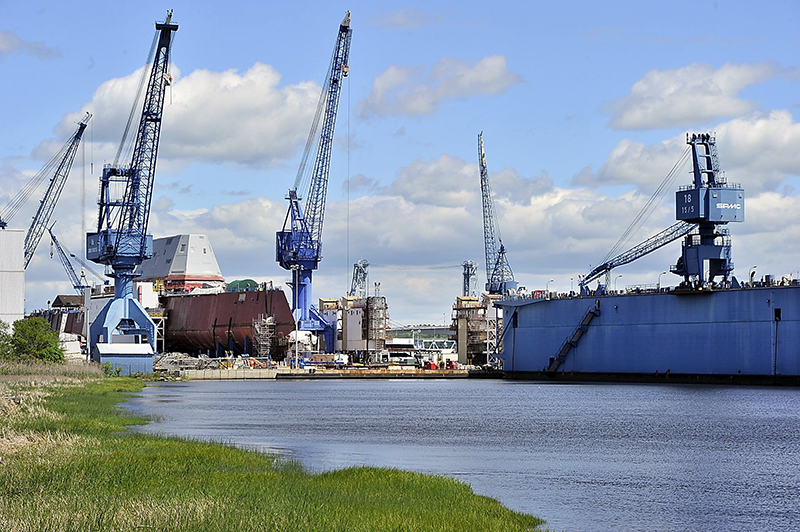 In this June 2013 file photo, the BIW complex of cranes, manufacturing buildings and, right, a dry dock, is seen on the Kennebec River.