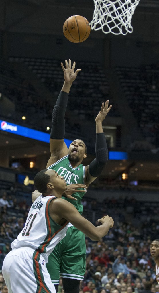 Jared Sullinger, who scored 21 points Saturday night for the Boston Celtics, lifts a shot over John Henson of the Milwaukee Bucks during the Bucks’ 92-85 victory.