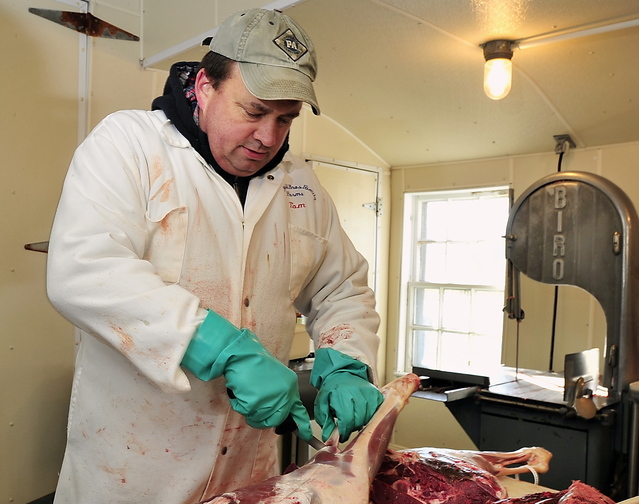Tom Blaisdell carries on a family tradition as he carves a hunter’s deer at York’s Blaisdell Bros. Family Farm, which every autumn becomes one of southern Maine’s most productive deer-processing facilities.
