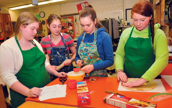 Skowhegan Area High School students in the basic foods class prepare to make pizza pockets. They are, from left: Emily Greaney, Mariah Bonneau, Laura Wolters and Monique Thompson.