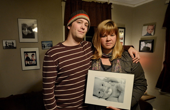 Nick Bowie-Haskell and Nicole Wheeler hold a photograph of their son Charlie in their home in South Portland on Nov. 25. The couple have started a fundraising campaign called “17 Days of Charlie” in their son’s memory. Proceeds will benefit another family and the Maine Children’s Cancer Program.