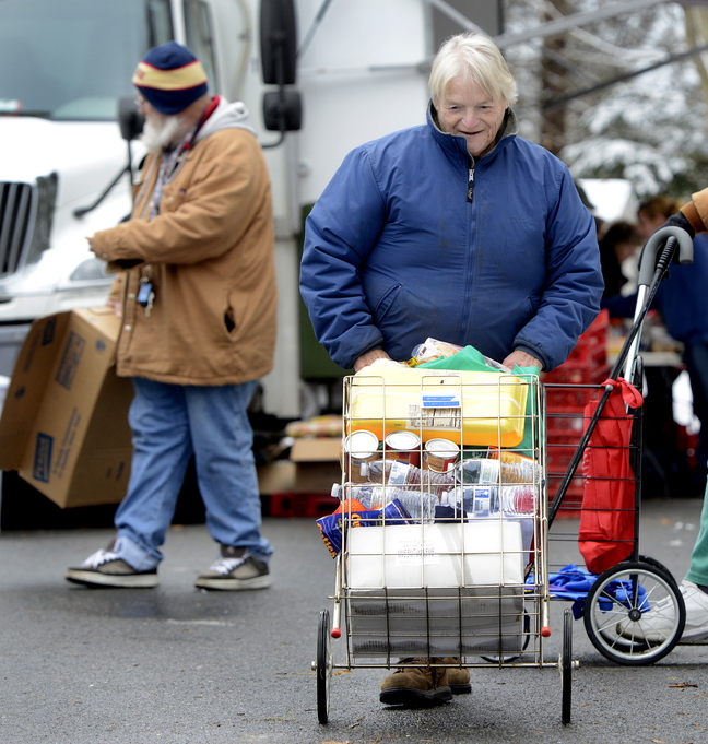 Donna Young of Woolwich pushes her cart after visiting the food truck.