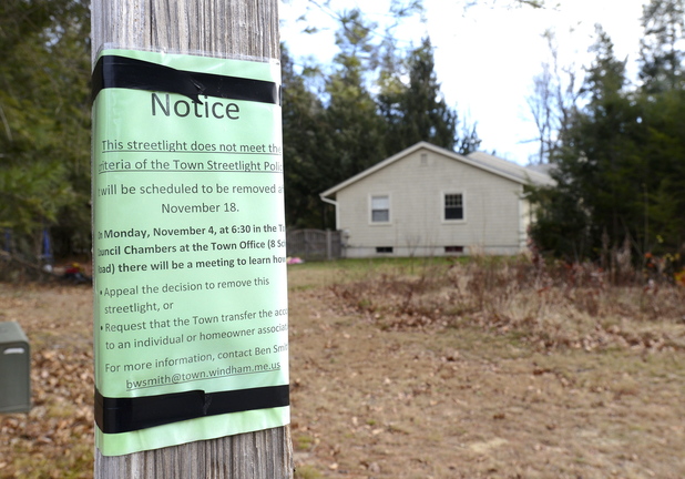 A notice is attached to a streetlight in Windham that is targeted for removal as a cost-cutting measure.