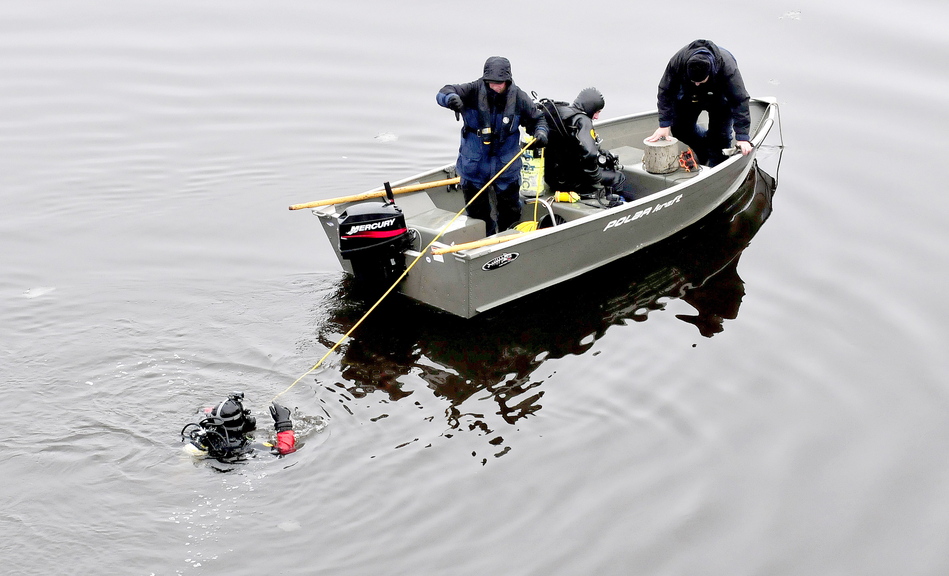 A diver is tethered to a boat Monday during a search for evidence related to the killing of Thomas Namer in Vassalboro.