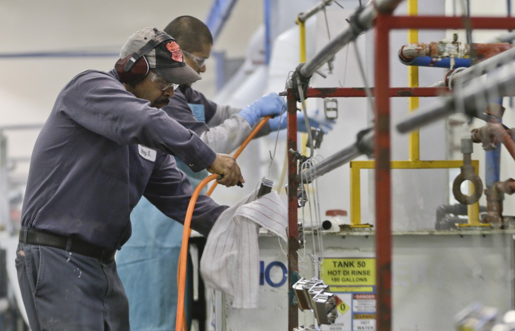 Employees at Sheffield Platers Inc. work on the factory floor in San Diego in October.