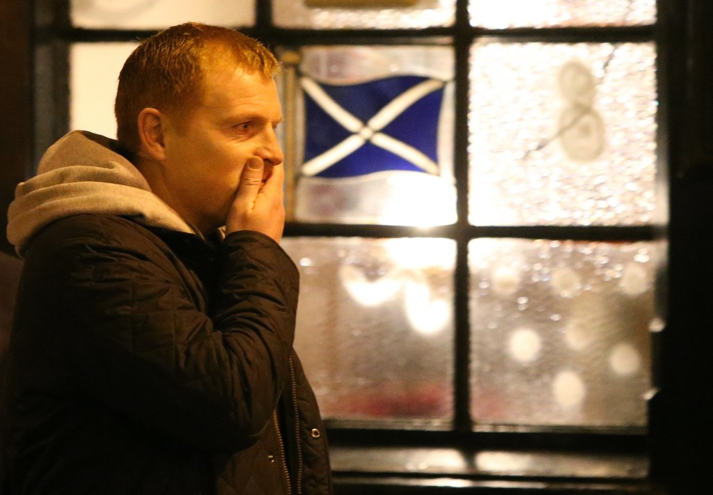 Celtic manager Neil Lennon gestures after laying flowers at the scene of the helicopter crash at the Clutha Bar in Glasgow, Scotland, on Monday. The crash of a police helicopter crash killed nine people and injured more than two dozen.