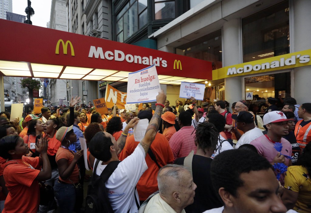 In this Aug. 29 file photo, protesting fast food workers demonstrate outside a McDonald's restaurant on New York's Fifth Avenue. Fast-food workers in about 100 cities will walk off the job Thursday to build on a campaign that began about a year ago to call attention to the difficulties of living on the federal minimum wage of $7.25 an hour.
