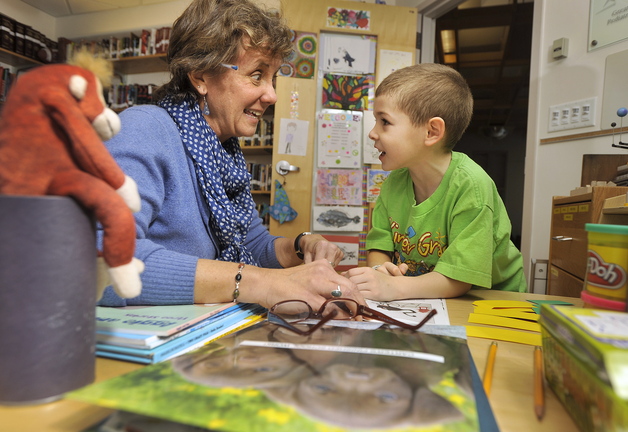 At top, teacher Abby Snyder works with patient Carter Blanche, 6, of Augusta, during a recent study session in her office at Maine Medical Center’s pediatric ward in Portland. Above, Snyder helps Carter with his writing skills.