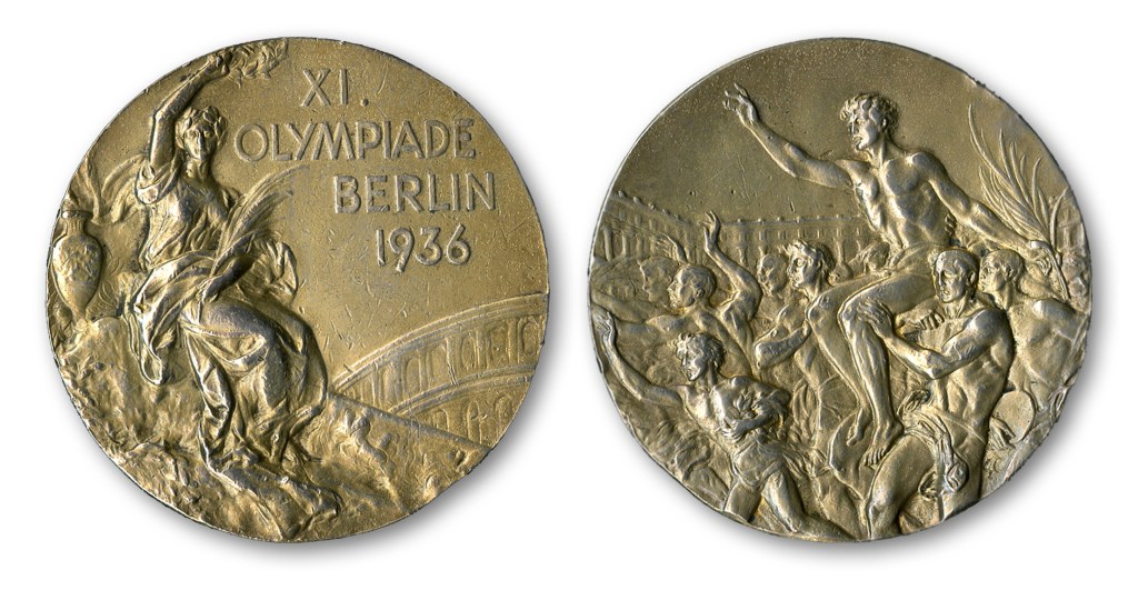 This handout provided by SCP Auctions, Inc., shows the front, left, and back, right, of one of Jesse Owens’ four gold medals won at the 1936 Olympics in Berlin.