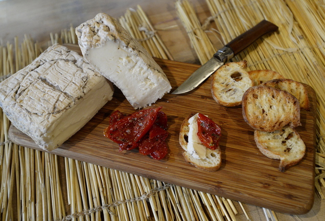 At The Cheese Iron in Scarborough, truffled cheeses, far left, and cave-aged taleggio from the Lombardy region of Italy are served with oven-roasted tomatoes.