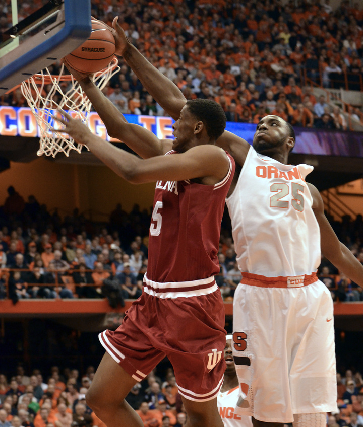 Syracuse’s Rakeem Christmas rejects a shot by Indiana’s Troy Williams in Tuesday night’s game at Syracuse, N.Y. The Orange improved to 8-0 with a 69-52 win.