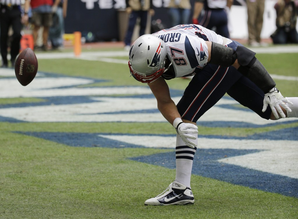 New England Patriots’ Rob Gronkowski celebrates a touchdown against the Houston Texans during the first quarter of an NFL football game Sunday, Dec. 1, 2013, in Houston.