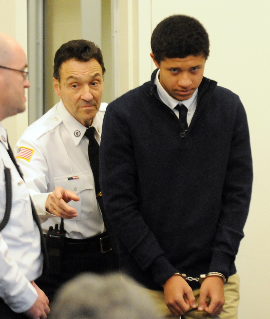 Phillip Chism, 14, is lead into Salem Superior Court on Wednesday in Salem, Mass. He is charged in the Oct. 22 killing of Colleen Ritzer, a Danvers High School teacher.