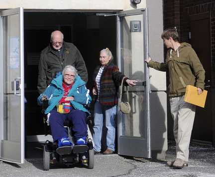 Religious and union leaders from Kennebec County emerge after a meeting with Stefanie Nadeau of MaineCare Services in Augusta Wednesday after meeting with her about medical ride problems.