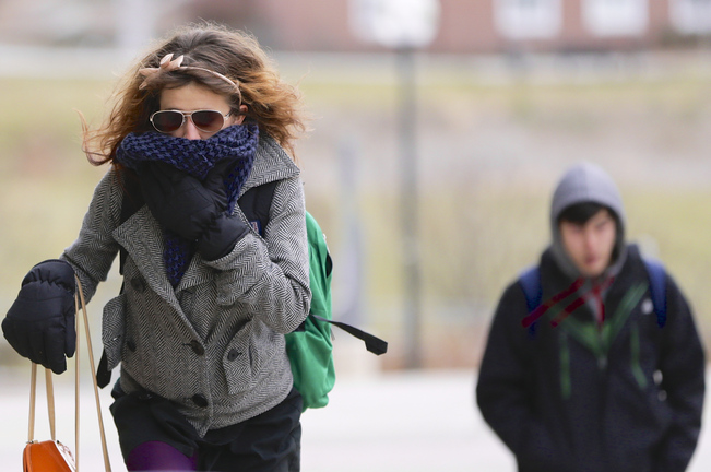 A student on the campus of the University of Nebraska-Omaha, in Omaha, Neb., tries to block out the cold Thursday as temperatures registered 13 degrees with a wind chill of minus 1.