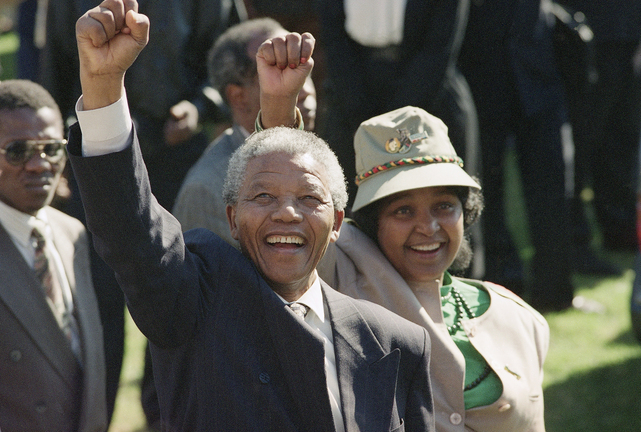 Nelson Mandela, newly elected as president of South Africa, and his wife, Winnie, greet the crowd on July 7, 1991, after arriving at a rally and a weeklong national African National Congressconference held inside South Africa for the first time in 30 years. Mandela has died at age 95.