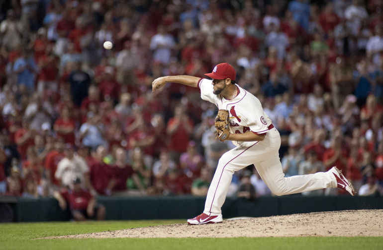 St. Louis Cardinals relief pitcher Edward Mujica throws during the ninth inning of an August baseball game against the Atlanta Braves. A person familiar with the deal tells The Associated Press that the Boston Red Sox and reliever Edward Mujica have agreed on a two-year contract.