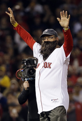 Carlton Fisk wears a beard as he throws out the ceremonial first pitch before Game 6 of baseball’s World Series between the Boston Red Sox and the St. Louis Cardinals on Oct. 30 in Boston. His beard is among the memorabilia from the Red Sox World Series run now on display at the National Baseball Hall of Fame and Museum.