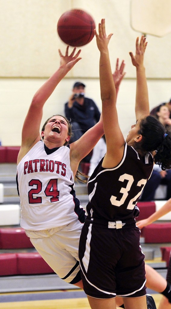 Maria Valente of Gray-New Gloucester puts up a shot over Kristina Smith of Greely while falling away. Valente, one of the top players in the state, finished with 24 points for the Patriots.