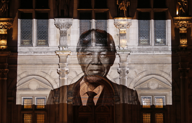 An image of late South African President Nelson Mandela is projected on the facade of Paris town hall Friday, as leaders around the world paid tribute to the anti-apartheid hero.