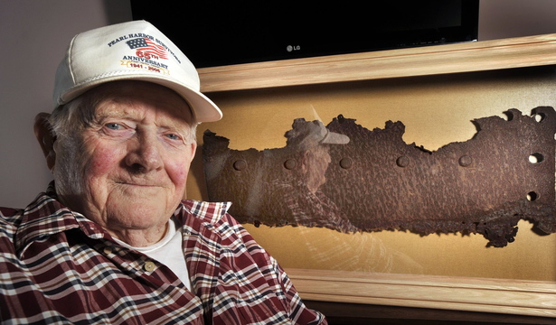 Bert Davis, a Navy veteran who lived through the attack on Pearl Harbor, is shown in 2012 with a rusted piece of steel from the USS Arizona that was unveiled on Dec. 7 at a ceremony at the Maine Veterans Home in South Paris.