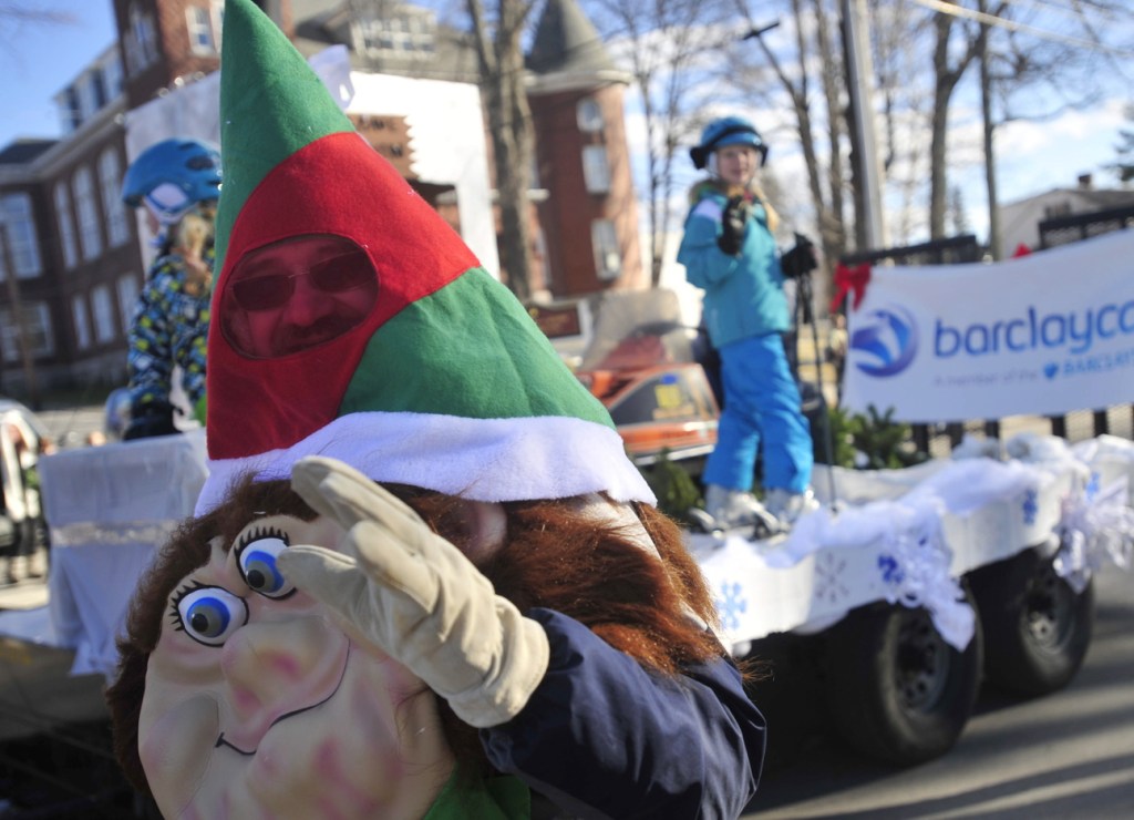 Dan Farrington, dressed as an elf, waves to the crowd on Main Street during the annual Chester Greenwood Day parade in downtown Farmington on Saturday.