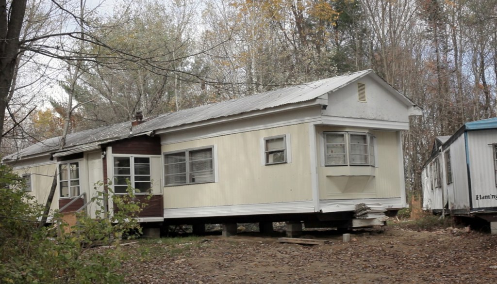 Julie and her son James live in this mobile home in West Paris. Growing up, James Reynolds spent much of his time next door, at the home of his grandparents. His grandfather, Daniel Paine Sr., who became a father figure to the boy, died in 2009. “James had a hard time with that,” says the family’s longtime pastor.