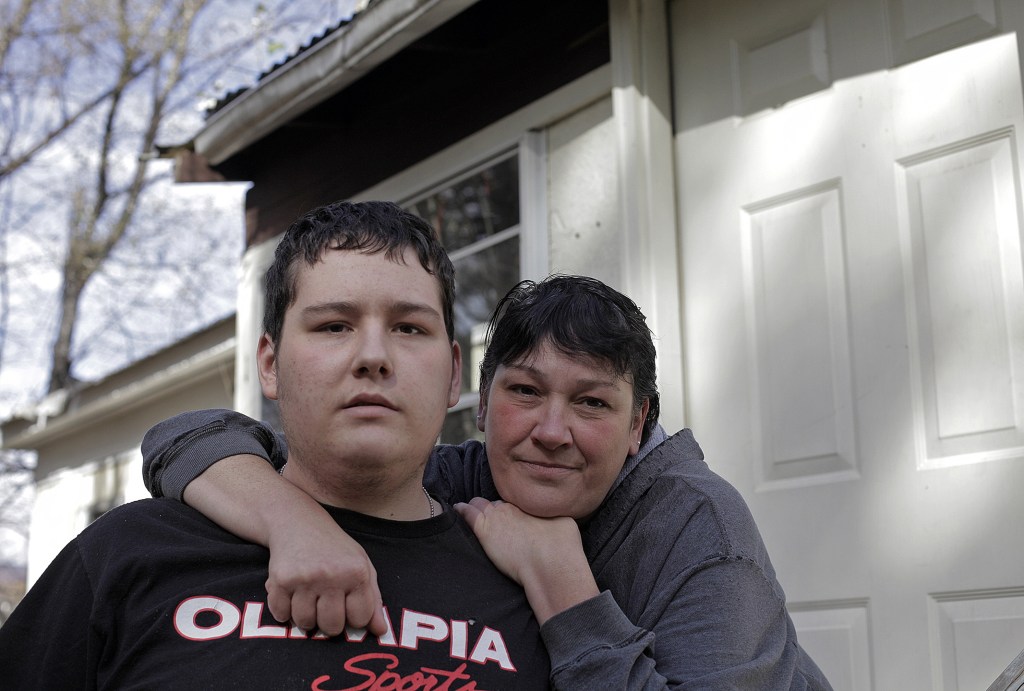 Eighteen-year-old James Reynolds and his mother, Julie, pose at their West Paris home in mid-October, four months after he was shot three times in a confrontation with Maine State Trooper Jason Wing. Julie says she relives the shooting every day, trying to understand what happened. “James has had a multitude of people who let him down, including me,” Julie said. “We didn’t recognize (the mental illness) until it was too late.”