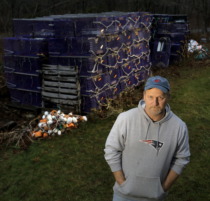 Shrimp fisherman Tim Simmons of Nobleboro stands next to the roughly 100 shrimp traps that won’t be used for the 2014 season.