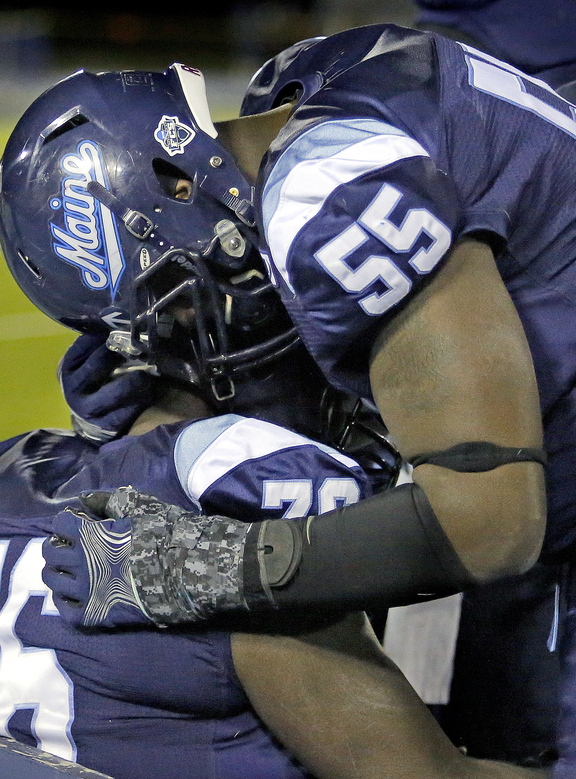 Bruce Johnson of UMaine, right, consoles teammate Tyler Patterson of Owls Head after the Black Bears fell 41-27 to New Hampshire in the NCAA playoffs Saturday at Orono. Maine lost only two games this season to FCS opponents, both to New Hampshire.