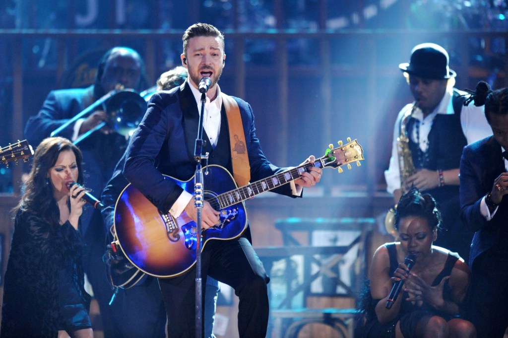 FILE - In this Nov. 24, 2013 file photo, Justin Timberlake, center, performs on stage at the American Music Awards at the Nokia Theatre L.A. Live in Los Angeles. Timberlake is among the clear favorites as The Recording Academy prepares to unveil its Grammy nominees on Friday, Dec. 6, 2013. A handful will be unveiled during a CBS special, and the rest announced after it airs.