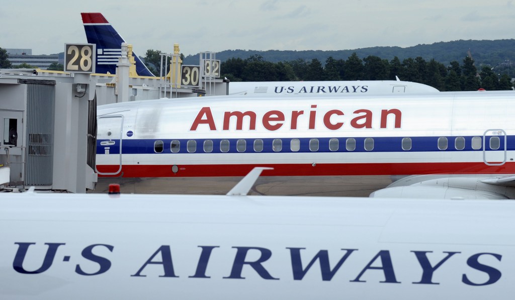 An American Airlines plane sits between two US Airways planes at Washington’s Ronald Reagan National Airport. The two airlines have merged.