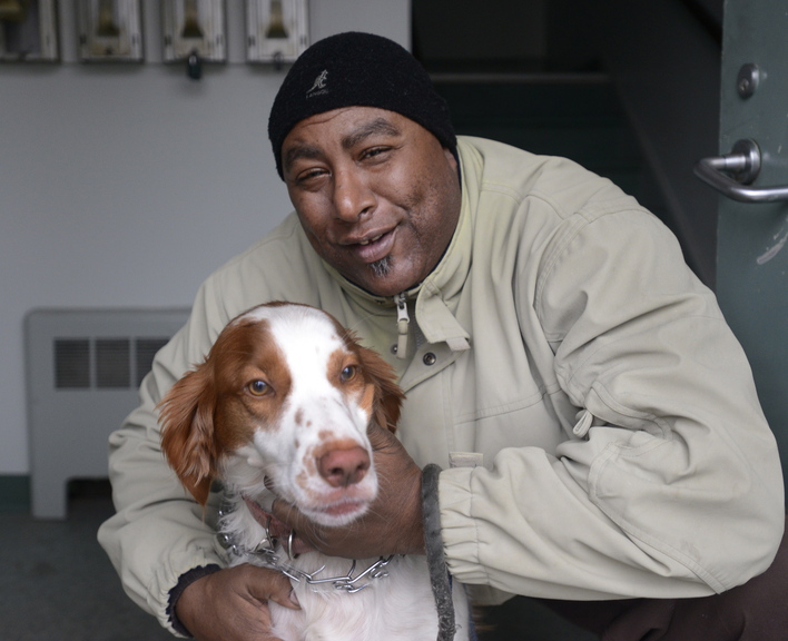 Ernesto Fernando of Portland holds his dog Boomer at his home. Fernando fought his citation for having an unleashed dog outdoors, but lost his case and was fined $75.