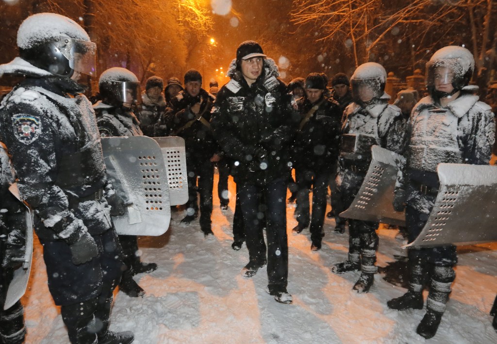Vitali Klitschko, a Ukrainian lawmaker and chairman of the opposition party Udar, is surrounded by police as they tried to prevent possible clashes in Kiev on Monday.