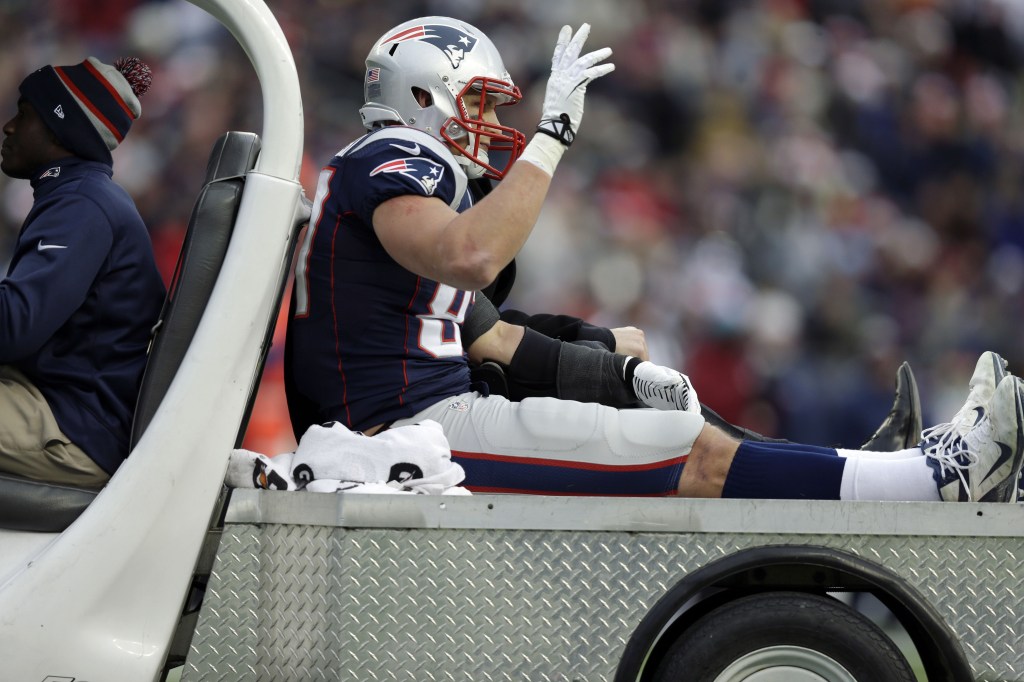 New England Patriots tight end Rob Gronkowski waves as he leaves the field in a cart after being injured in the third quarter of the game against the Cleveland Browns Sunday in Foxborough, Mass.