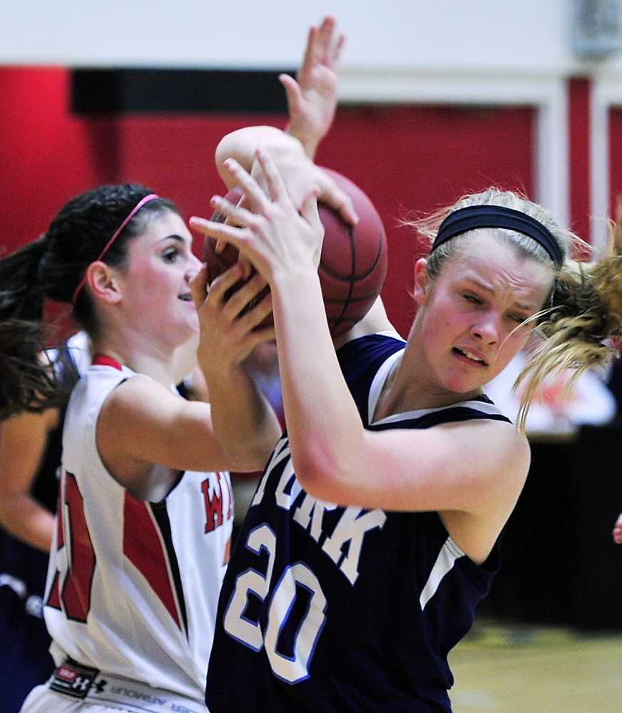 Chloe Smedley of York, right, pulls down a rebound from Taryn Lambert of Wells during their Western Maine Conference game Tuesday night. Wells opened a 16-6 lead after one quarter and went on to a 57-38 victory.