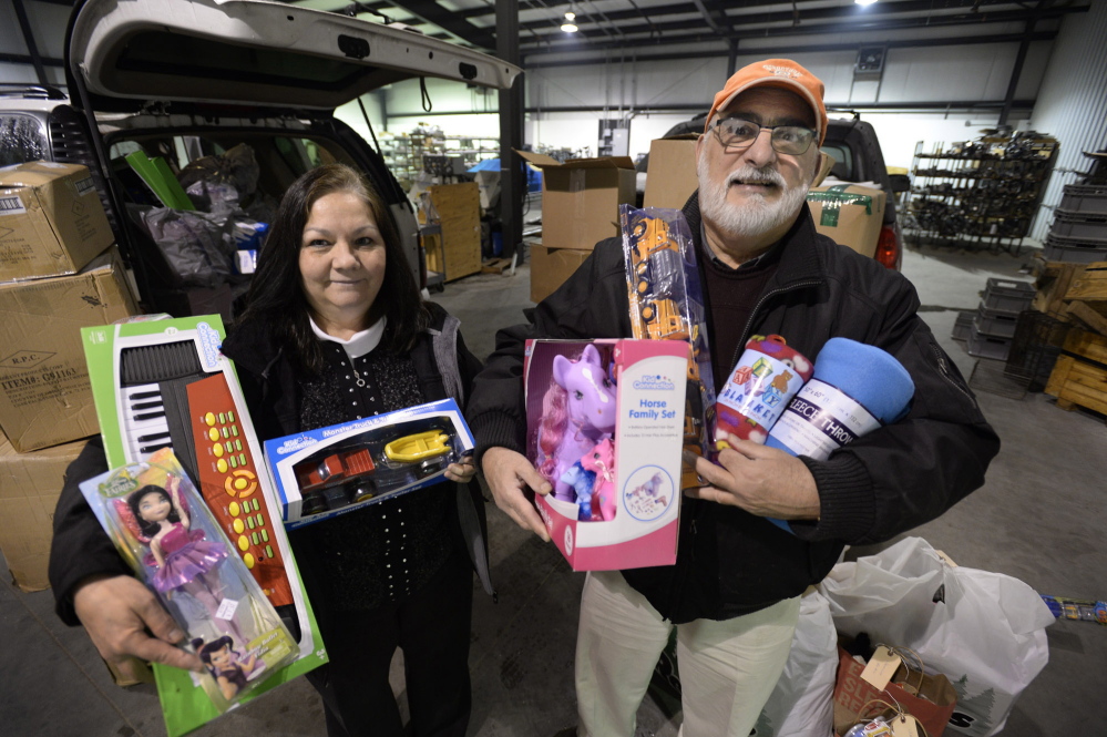 Carole and Paul Deschambault hold some of the toys that will be taken to Lac-Megantic over the next few days to help the town’s residents.