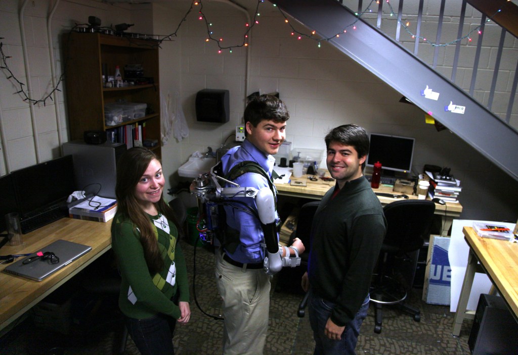 Nick McGill wears the Titan Arm, as he poses alongside his student colleagues Elizabeth Beattie and Nick Parrotta at the University of Pennsylvania in Philadelphia. The robotic device invented along with a fourth student, Niko Vladimiro, builds on existing research in the field of exoskeletons, an area that experts say will grow as the population ages.