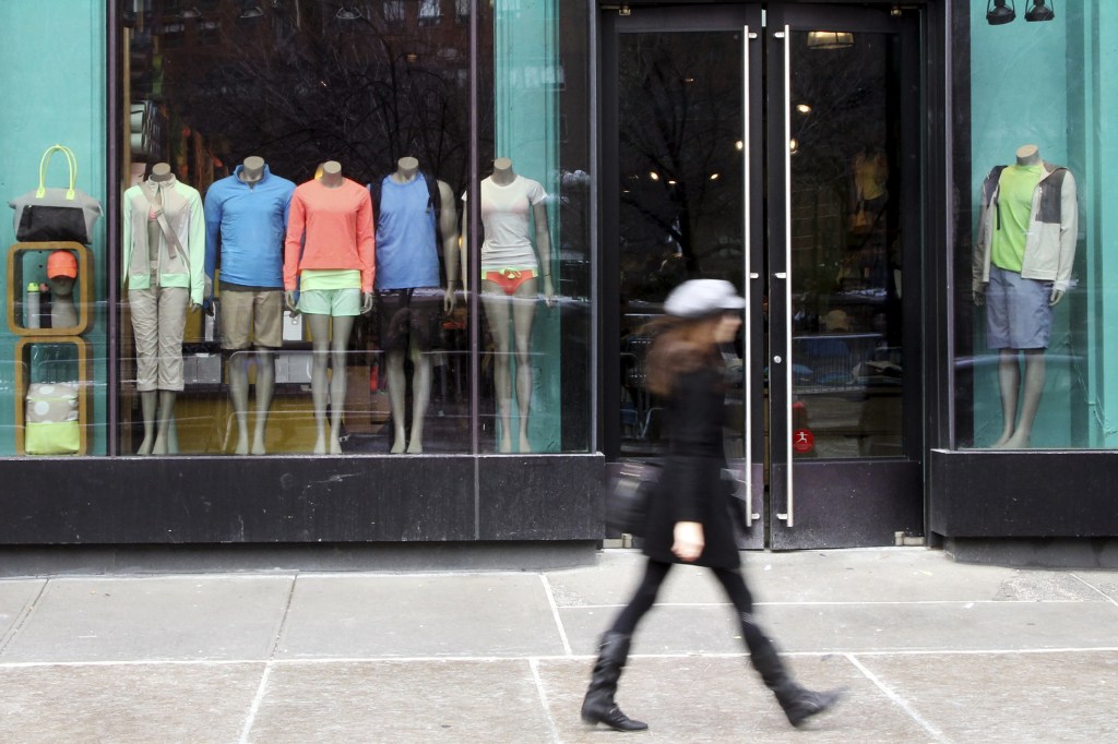 FILE - In this Tuesday, March 19, 2013, file photo, a woman walks past the Lululemon Athletica store at Union Square in New York. The company said Tuesday, Dec. 10, 2013 that Lululemon founder Chip Wilson is stepping down as chairman after raising ire with his comments about the body types of potential buyers of the retailer's yoga pants. (AP Photo/Mary Altaffer, File)