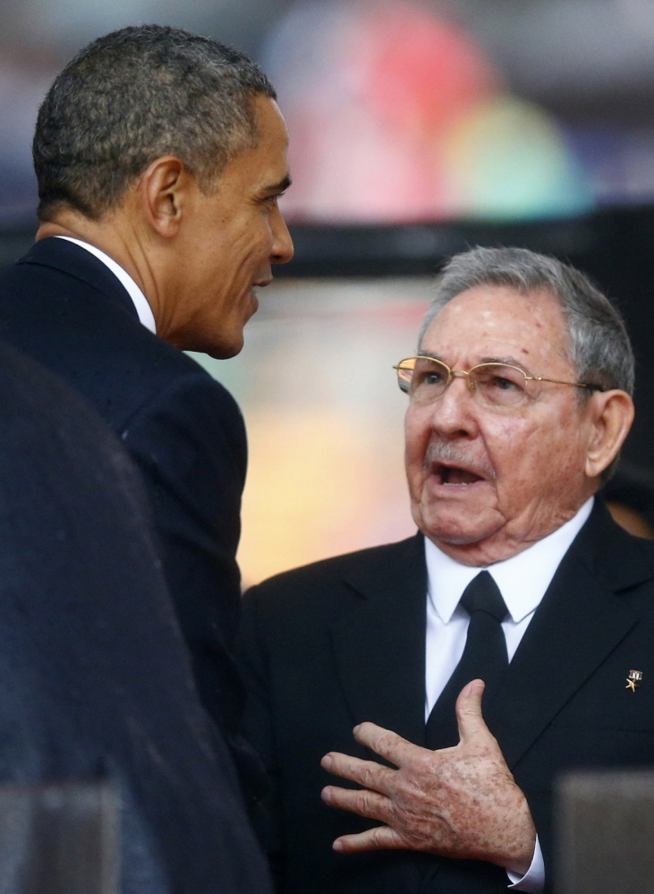 President Obama greets Cuban President Raul Castro before giving his speech.