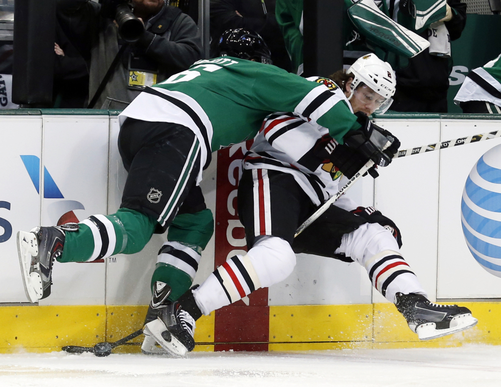 Stars left wing Ryan Garbutt, left, knocks Blackhawks defenseman Duncan Keith to the ice during the first period of Chicago’s 6-2 win at Dallas.