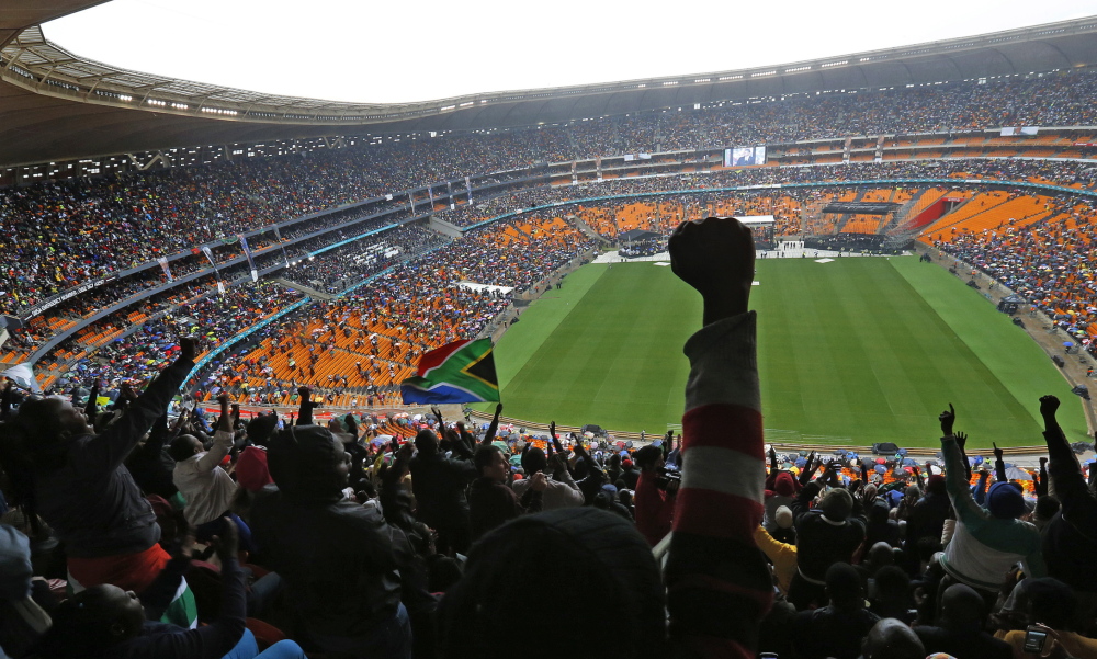 People cheer as President Obama speaks at FNB Stadium in Soweto, South Africa, on Tuesday during the national memorial service for Nelson Mandela.