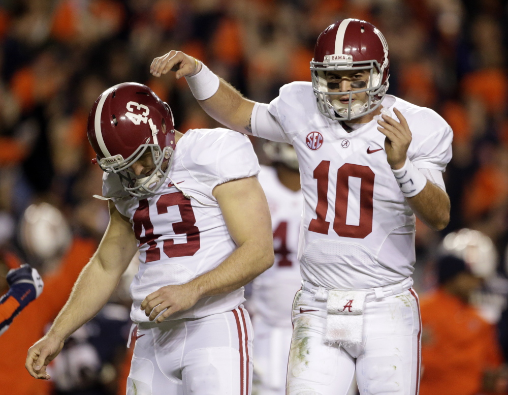 Alabama quarterback AJ McCarron (10) consoles kicker Cade Foster (43) after he missed a field goal against Auburn during the first half of an NCAA college football game in Auburn, Ala., Saturday, Nov. 30, 2013.