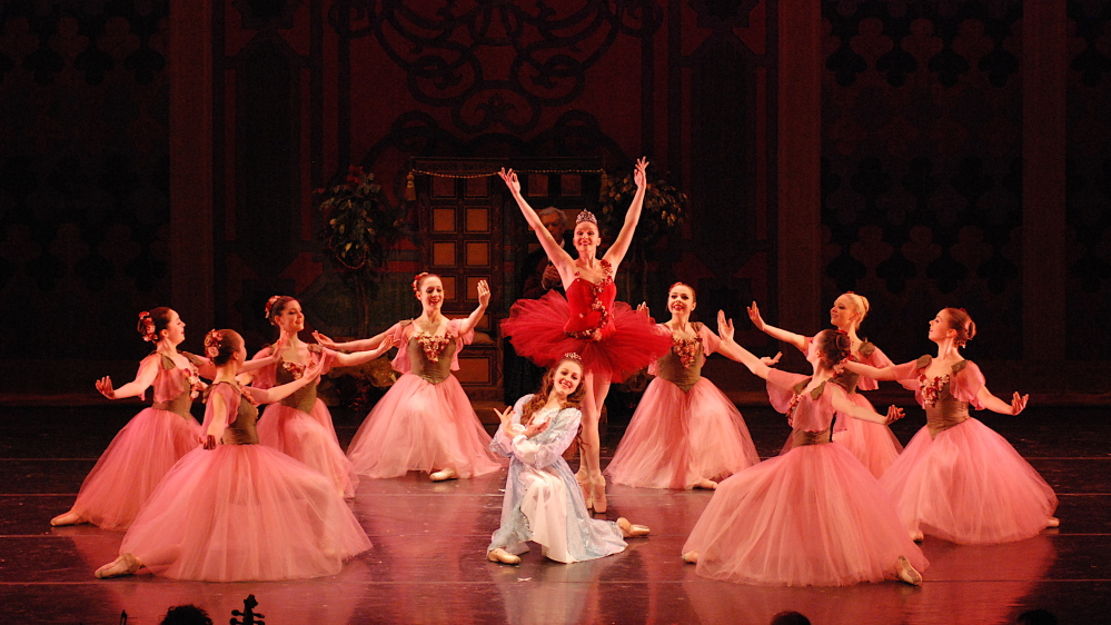 Amelia Bielen as Rosebud (in red tutu) and Emily Avery as Olivia (traditionally Clara) take center stage in the "Waltz of the Flowers" in a prior production.