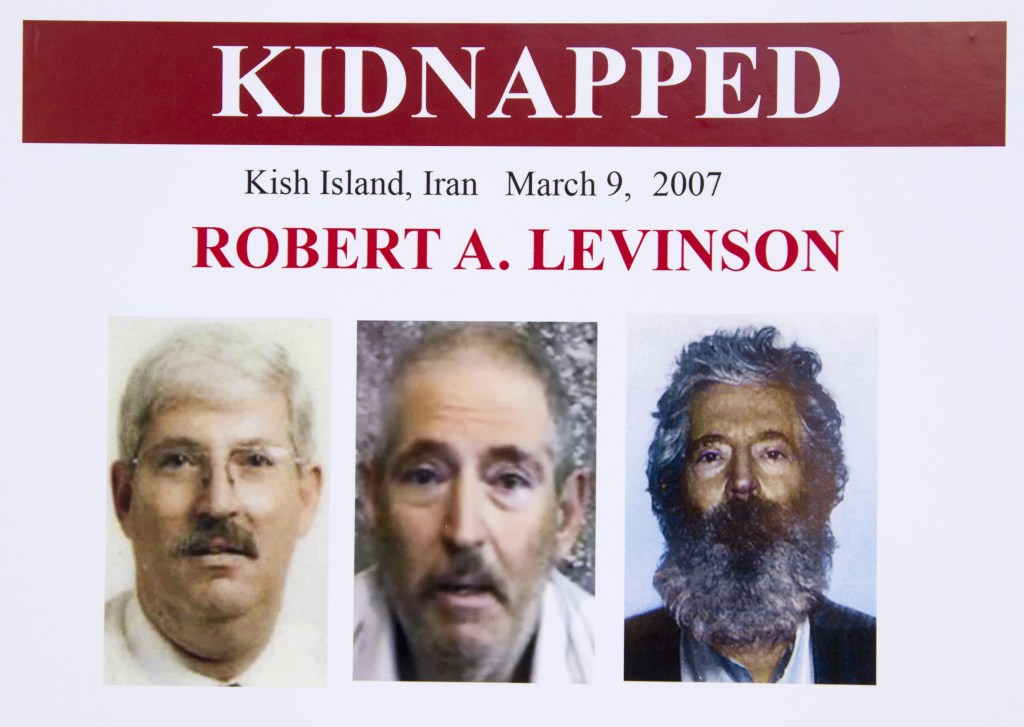 An FBI poster showing a composite image of retired FBI agent Robert Levinson, right, of how he would look like now after five years in captivity, and an image, center, taken from the video, released by his kidnappers, and a picture before he was kidnapped, left, displayed during a news conference in Washington, on March 6, 2012. The FBI announced a reward of up to $1,000,000 for information leading to the safe location, recovery and return of Levinson, who disappeared from Kish Island, Iran, on March 9, 2007.
