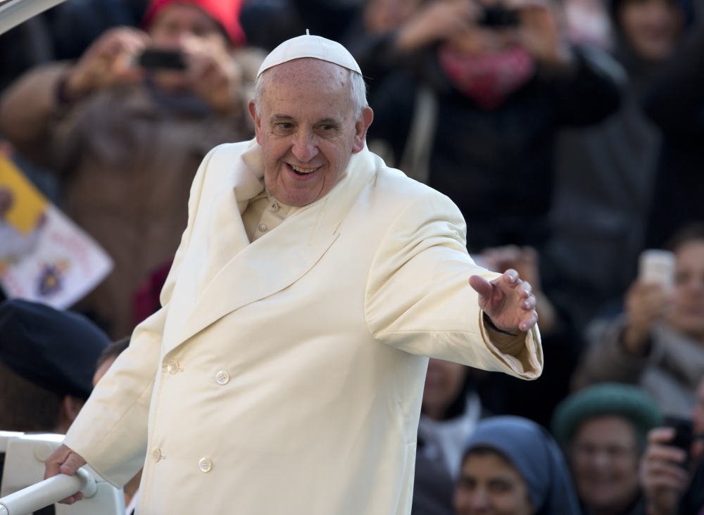 Pope Francis waves as he arrives for his weekly general audience in St. Peter’s Square at the Vatican on Wednesday. The pope has ramped up the reforms, forming two commissions of inquiry into the Vatican’s finances.