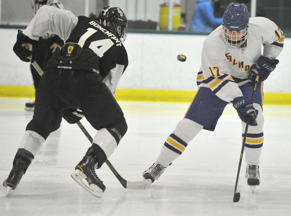 St. Dominic’s Bryan Bonenfant, left, and Falmouth’s Brandon Peters have been told to keep their sticks on the ice, but that’s not where the puck is during Thursday night’s game at Family Ice Center.